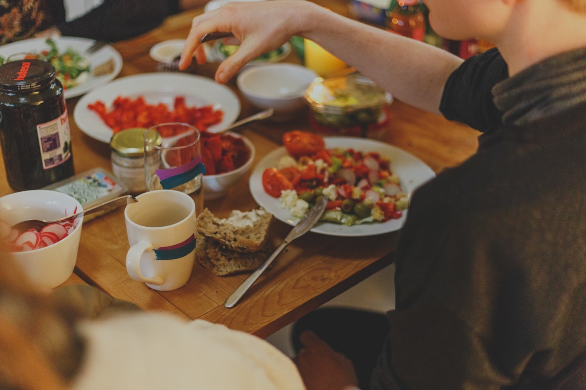 Man preparing healthy meal with fresh vegetables and whole grains
